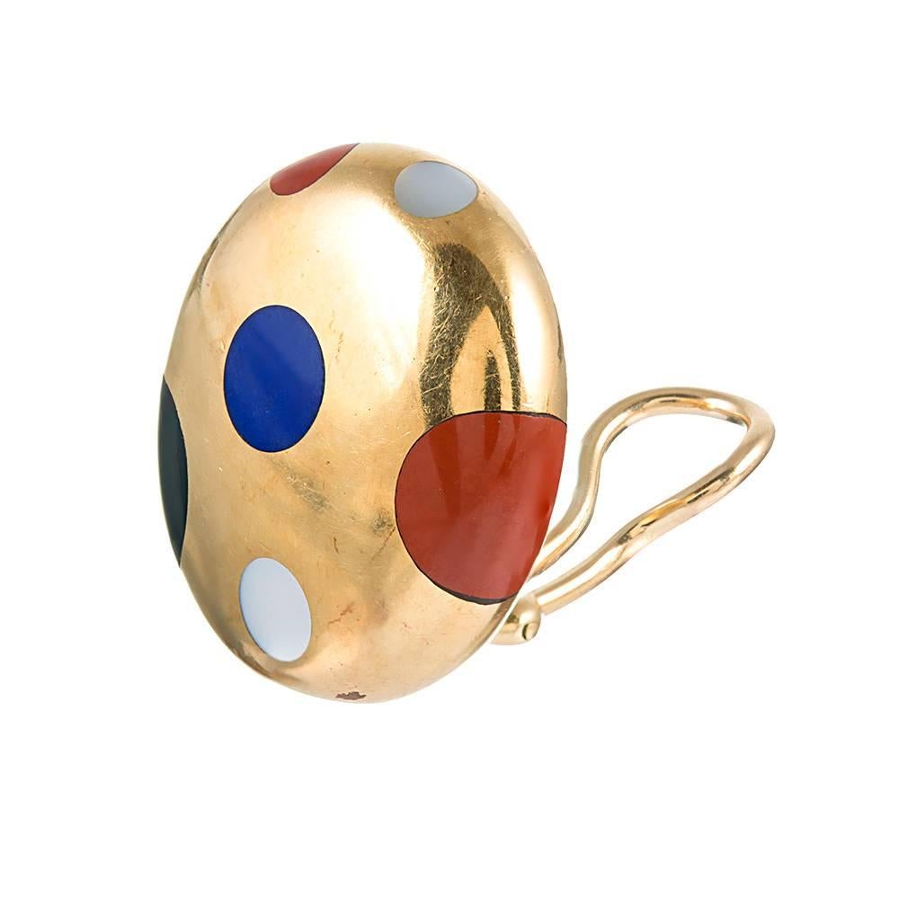 The earrings measure a hint under 1 inch by just under ¾ of an inch and are rendered in 18 karat yellow gold. Decorated with a polka-dotted pattern of inlaid carnelian, lapis, onyx & mother-of-pearl, they offer a stylish and sophisticated look
