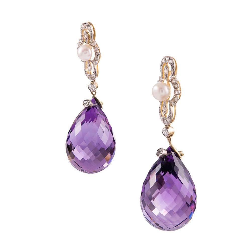 Large faceted teardrops of amethyst have visual appeal without excessive weight in these lovely earrings. Circa 1910