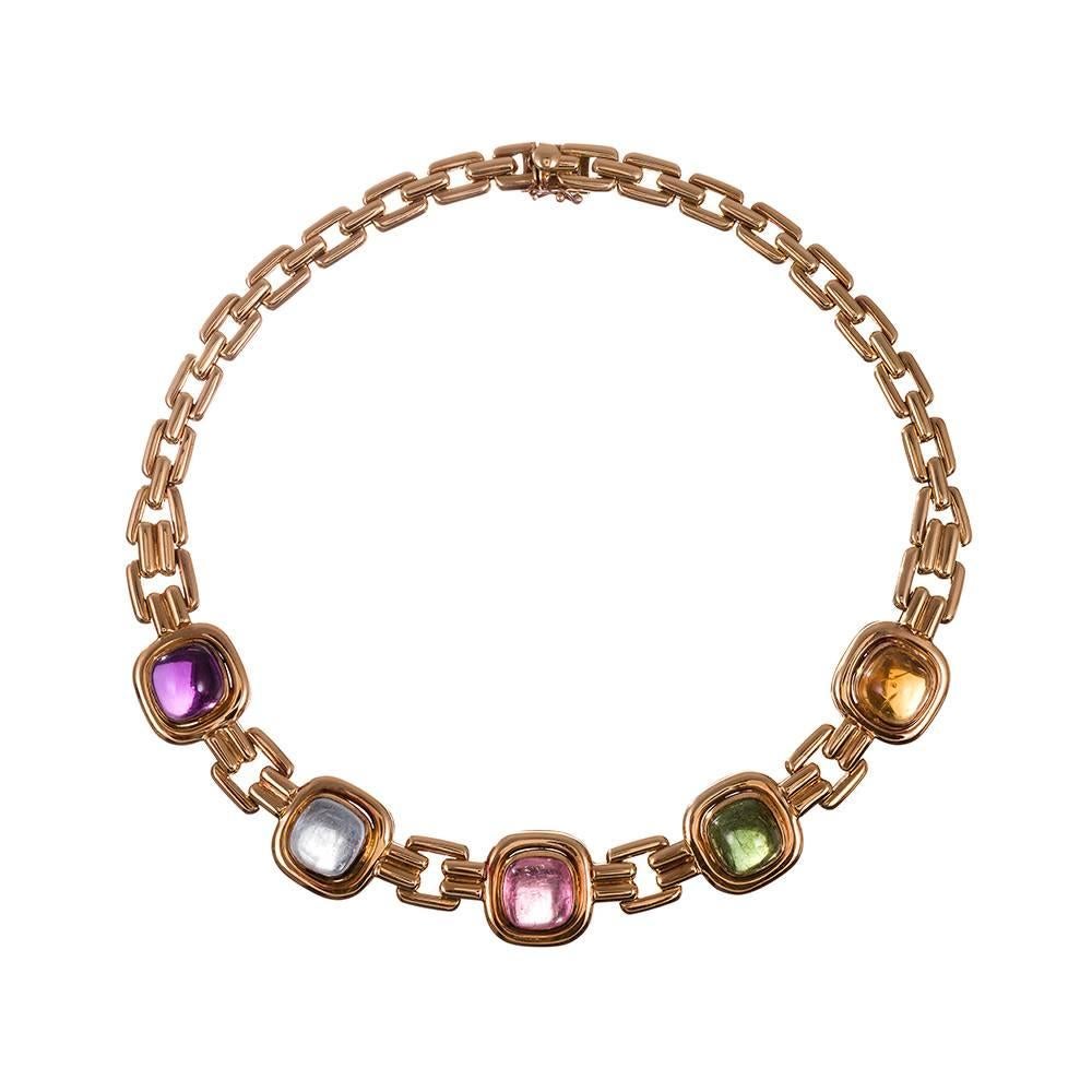 18k yellow gold collar that sits beautifully fixed on the neck, set with a large cabochon amethyst, aquamarine, pink and green tourmaline and a citrine. The unique geometric design with double-barreled connections between links creates a striking