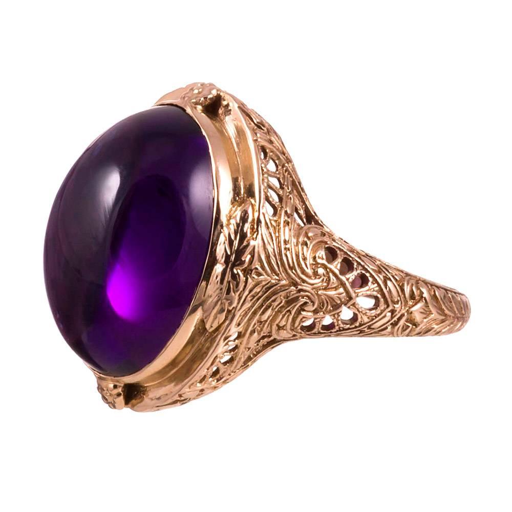 Hand pierced filigree mounting of 14k yellow gold containing a large amethyst cabochon. A regal look that is suitable for daily wear. Striking detail that was clearly executed by an initiated master. Size 9 can be altered on request.