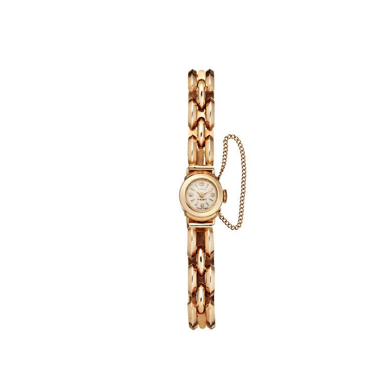 Olma lady's 18k rose gold bracelet watch. Round dial with Arabic numerals and baton indexes. Swiss 17-jewel manual-wind mechanical movement. Circa 1940s.