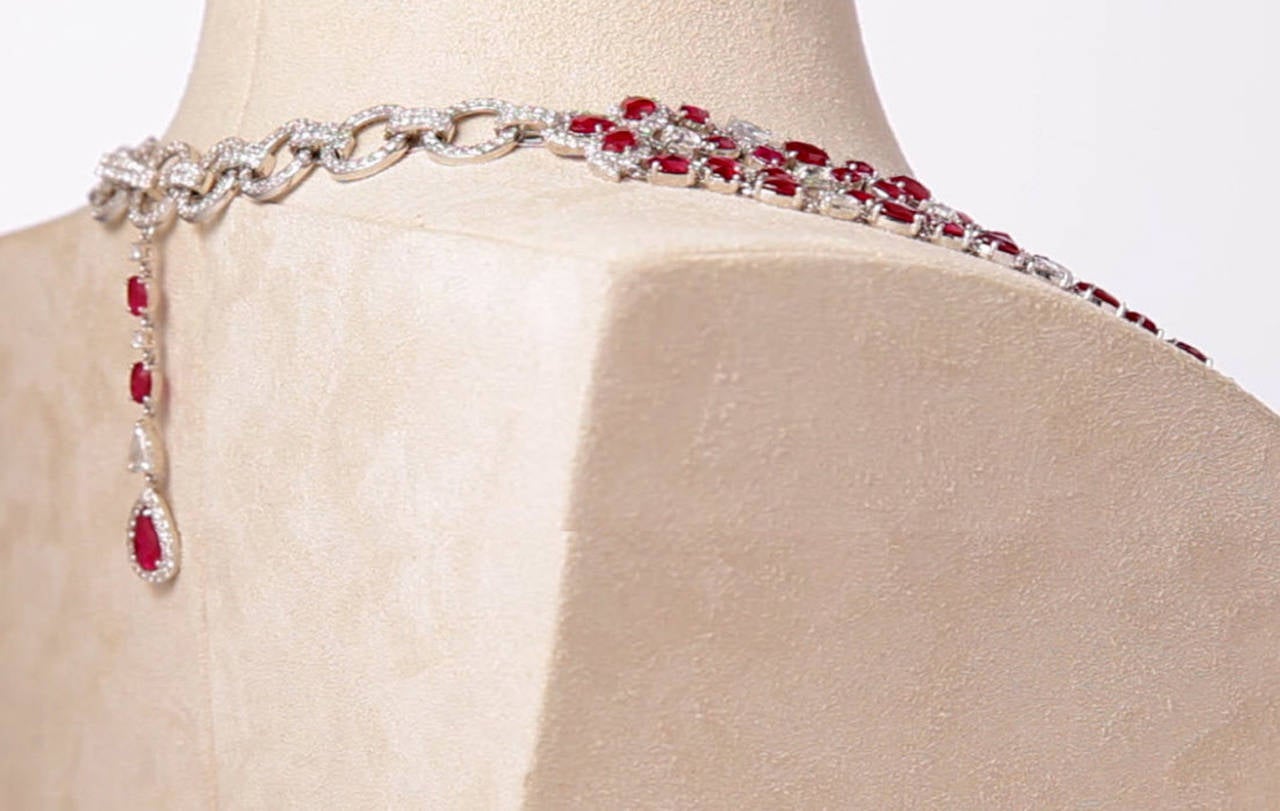 If you're seeking a truly memorable and magnificent statement necklace, look no further.   With a combination of cushion-cut, rose-cut, and oval rubies, this piece is simply spectacular.  
Crafted in 18k white gold, this collar-style necklace sits
