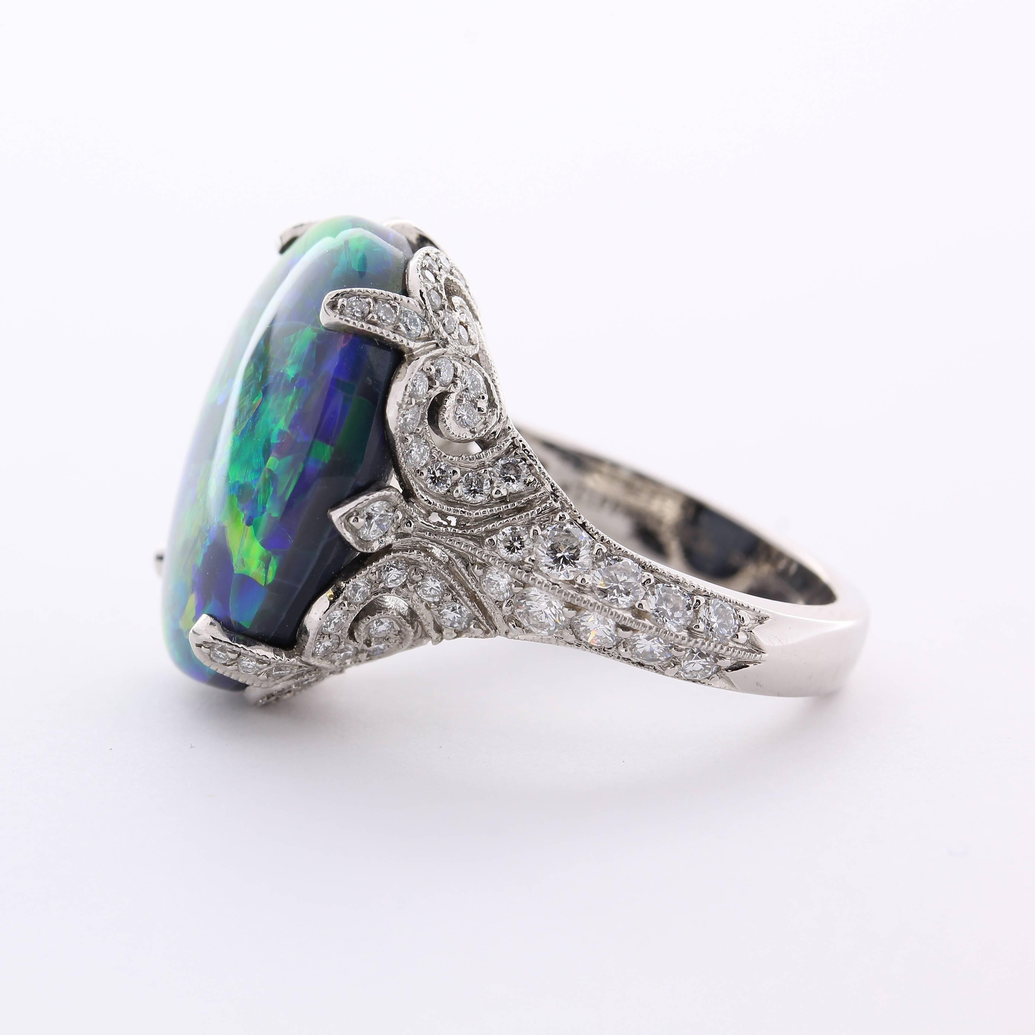 Crafted in platinum, this exceptional Tiffany and Company black opal and diamond ring is a distinctive heirloom-quality piece.  

The rich play of color in this flash black opal gives it an unsurpassed splendor and mystique.  Opal is one of the most