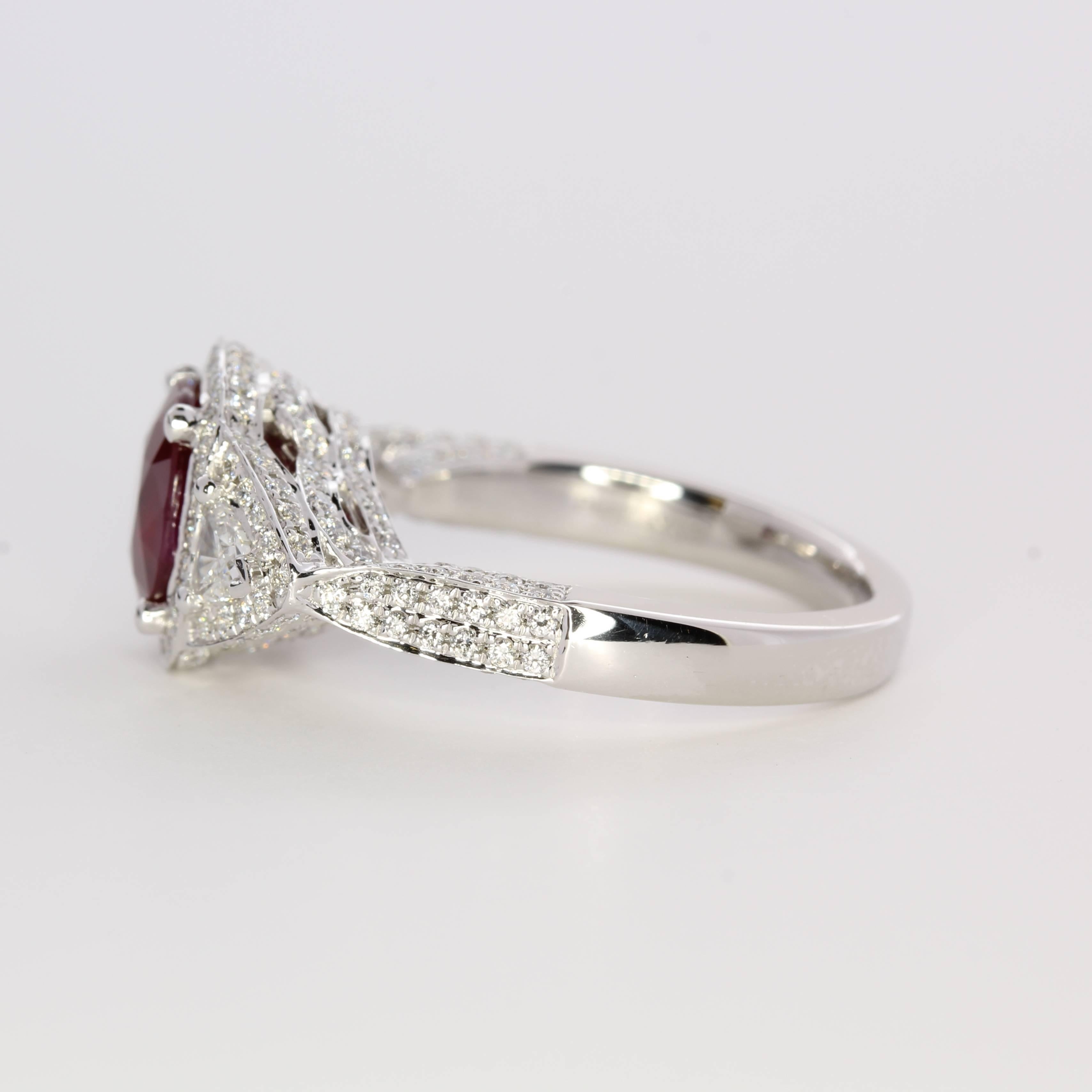 Handcrafted in precious platinum, this natural ruby displays a stunning pigeon’s blood, vivid red hue. A cushion-cut at 2.03 carats, the center gemstone is a beautiful display of Mother Nature at her best. Originating in Myanmar/Burma, the ruby is a