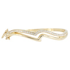 Bracciale rigido ondulato in oro giallo 14 carati con diamanti per un totale di 1,00 carati