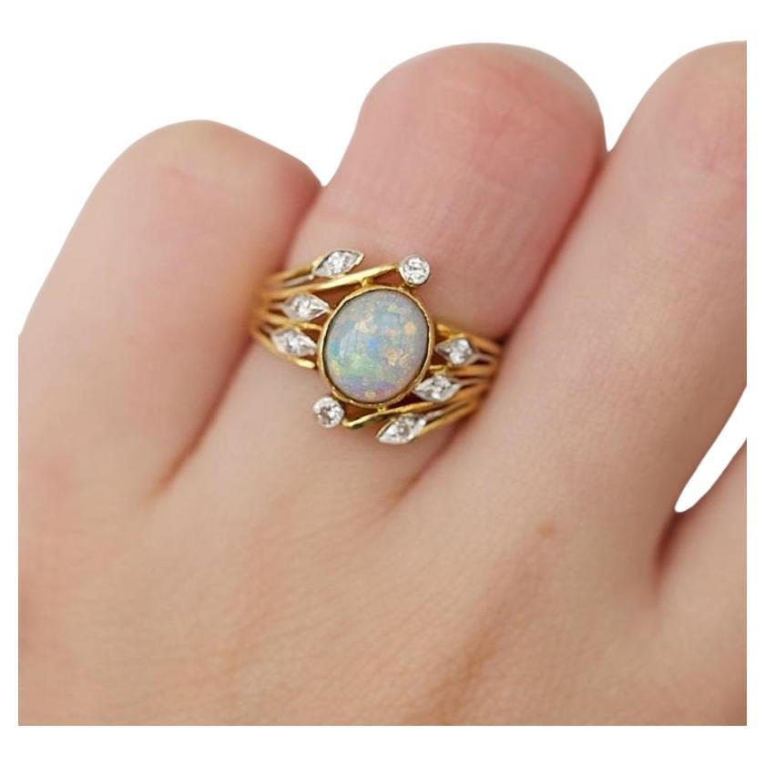 Beautiful 20k yellow gold opal diamond ring. This ring comes with NGI report and a fancy box.

-1 opal main stone 
cut: oval
color: faint orangy yellow
measurement: 8.18 x 7.15 mm

-8 diamond side stones of 0.015 ct., total: 0.12 ct.
cut: round