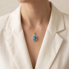 Radiant Blue Opal Cabochon with 0.30ct Diamond Halo Pendant in 18K Two-Tone Gold