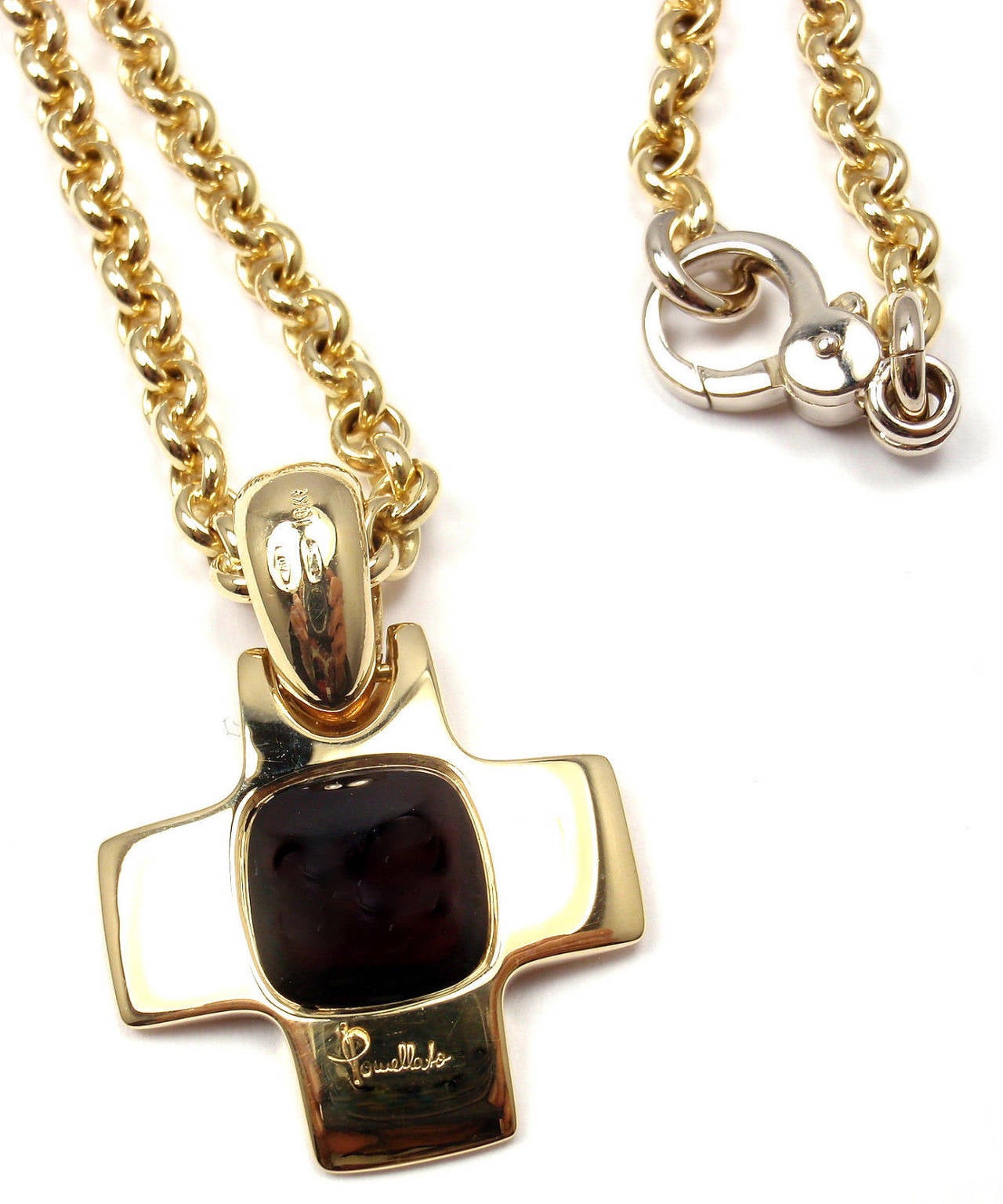 18k Yellow Gold Garnet Cross Pendant Link Necklace by Pomellato. 
With One garnet 11mm x 11mm

This necklace comes with original box and certificate.

Details: 
Weight: 37.9 grams
Chain - Length: 16