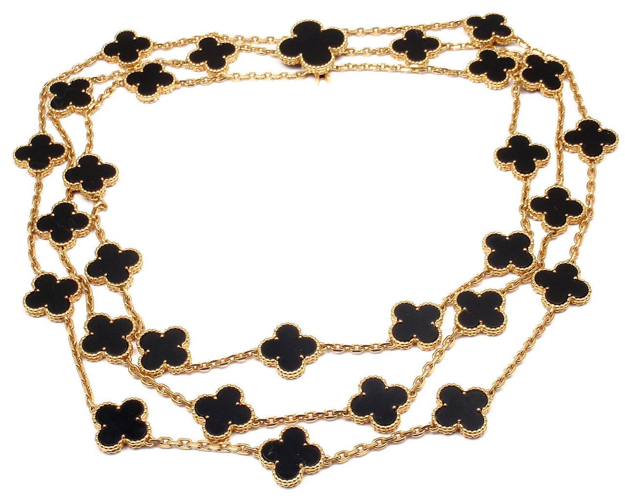 18k Yellow Gold 29 Vintage Alhambra motifs 3 Row Necklace by Van Cleef & Arpels.
With 28 black onyx motifs alhambra 15mm each and 1 black alhambra 21mm

Metal: 18k Yellow Gold
Length: 16