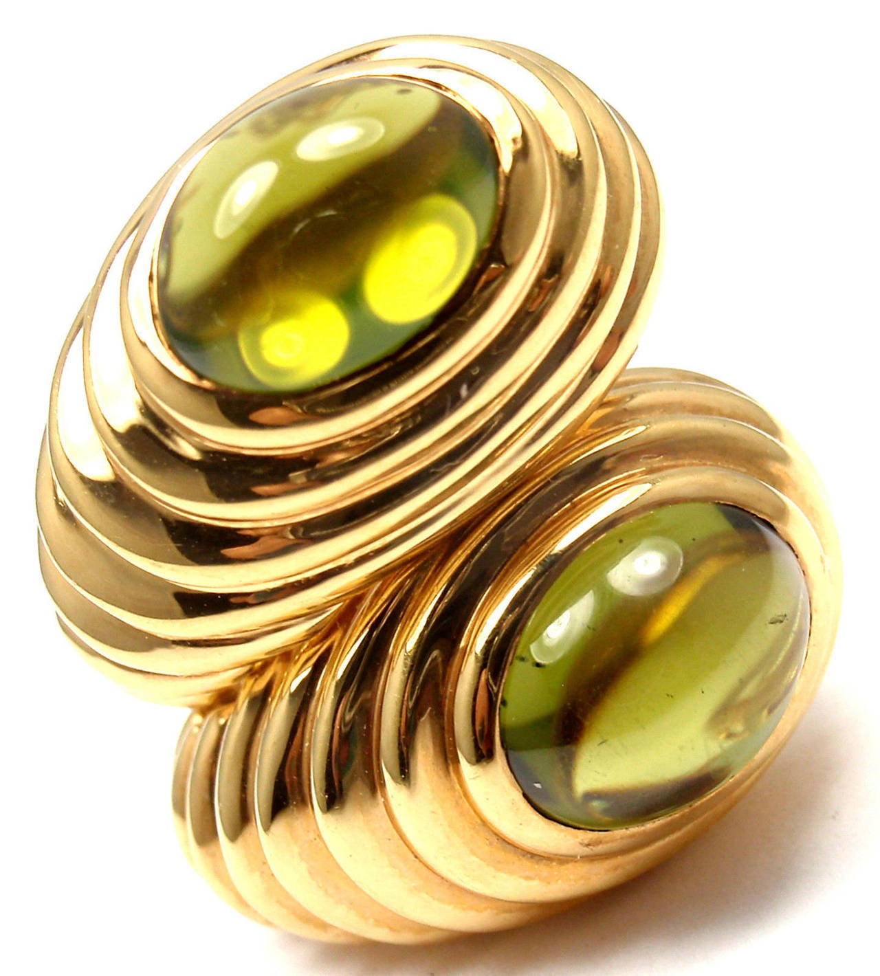 18k Yellow Gold Cabochon Peridot Earrings by Bulgari. 
With 2 oval cabochon peridots 10mm x 9mm

Details: 
Measurements: 21mm x 13mm
Weight: 18.5 grams
Stamped Hallmarks: Bvlgari, 750, 1970AL
*Free Shipping within the United States*

YOUR