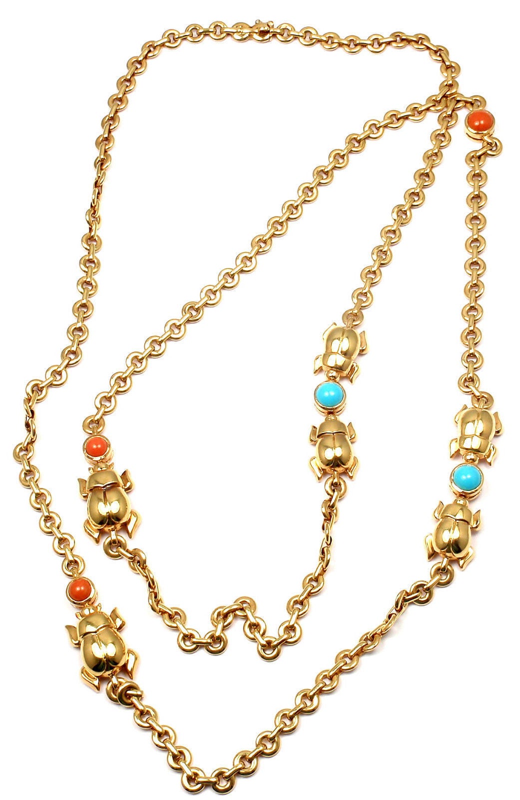 18k Yellow Gold Turquoise and Coral Scarab Link Necklace by Cartier.
With 3 round corals and 2 round turquoise
This necklace comes with an original Cartier box.

Details:
Length: 33
