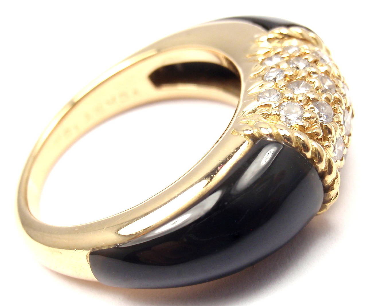 18k Yellow Gold Diamond & Black Onyx Ring by Van Cleef & Arpels. 
With24 round brilliant cut diamond VS1 clarity, G color total weight .70ct
Onyx. And 2 beautiful black onyx stones.

Details: 
Size: 6
Width: 18mm
Weight: 7.2 grams
Stamped