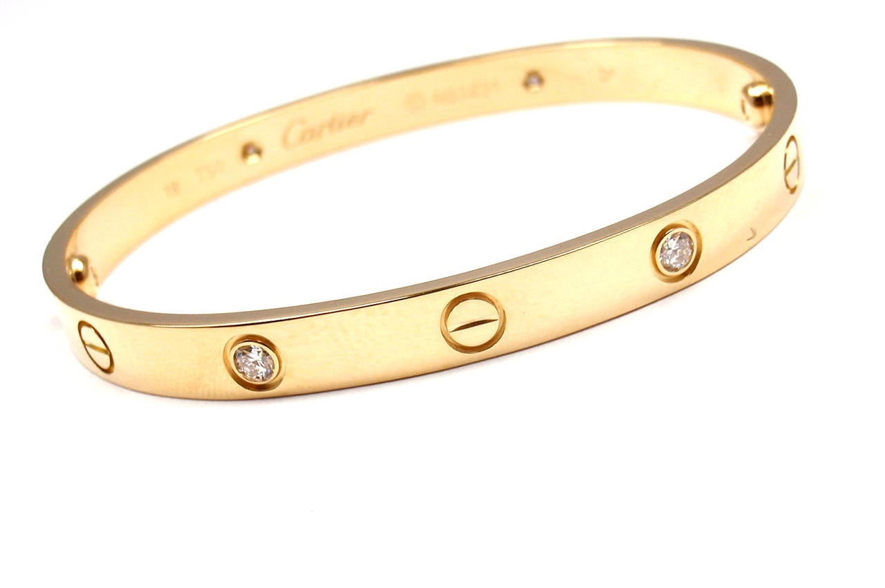 18k Yellow Gold 4 Diamond Cartier LOVE Bangle Bracelet. Size 18. 
This bracelet comes with an original Cartier box, screwdriver and Cartier certificate. With 4 round brilliant cut diamonds, VVS1 clarity, E color. 
Total Diamond Weight: .20CT.