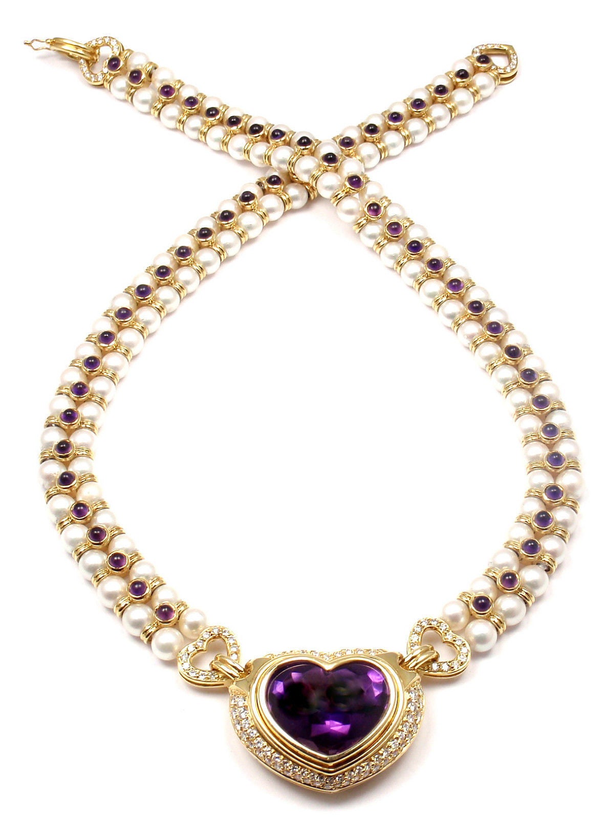 18k Yellow Gold Diamond Amethyst Pearl Necklace by Bulgari.
With 110 round brilliant cut diamonds VS1 clarity, G color total weight approx. 2.5ct
1 Large heart shape amethyst 22mm x 19mm
56 round amethysts 3mm each
112 cultured round pearls 6mm