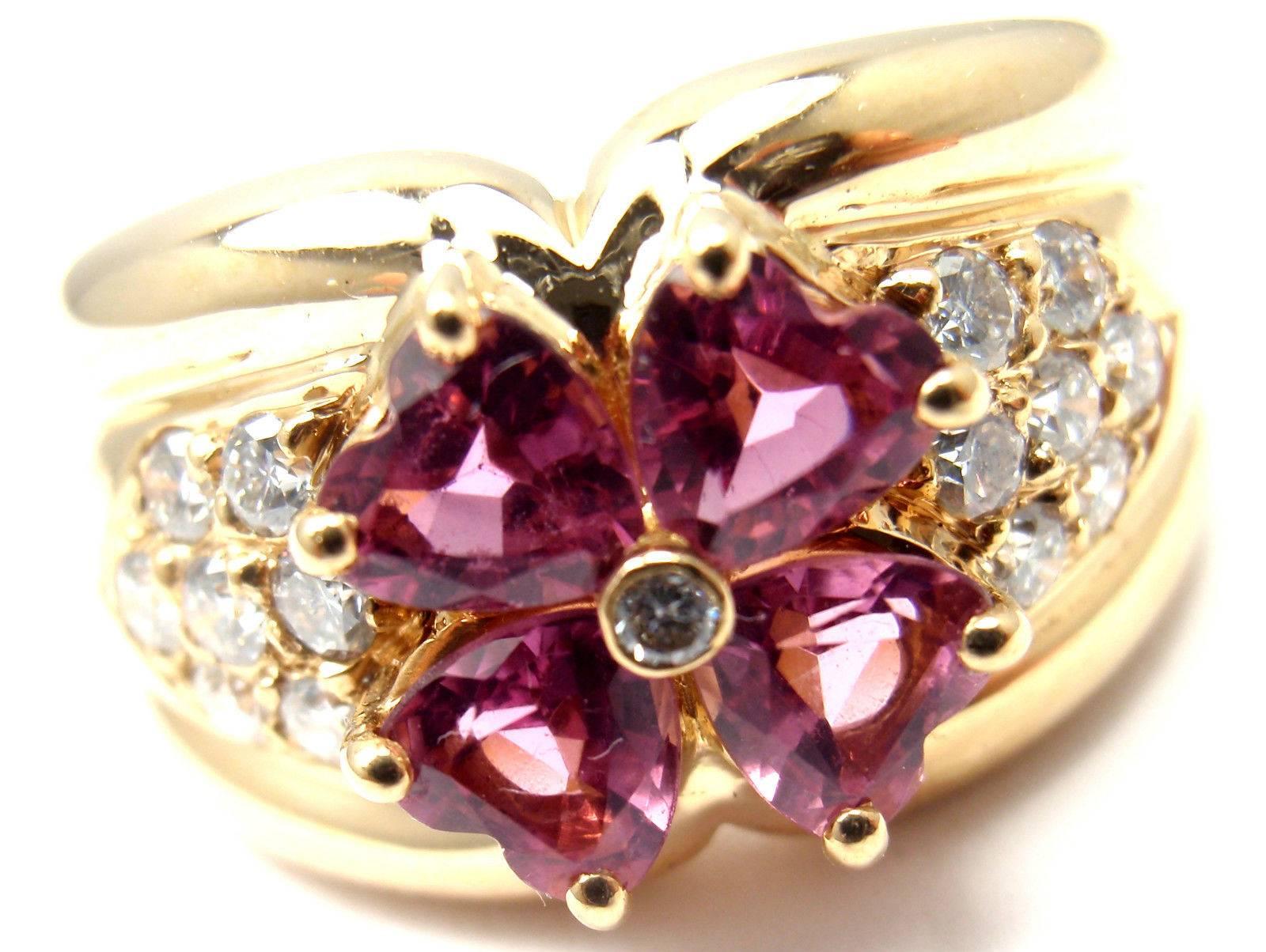 18k Yellow Gold Diamond & Pink Sapphire Flower Ring by Van Cleef & Arpels.
With 12 diamonds VVS1 clarity, E color
total weight approx. .50ct
4 heart shape pink sapphires total weight approx. 1ct

Details:
Ring Size: 6
Width: 12mm
Weight: 9.4