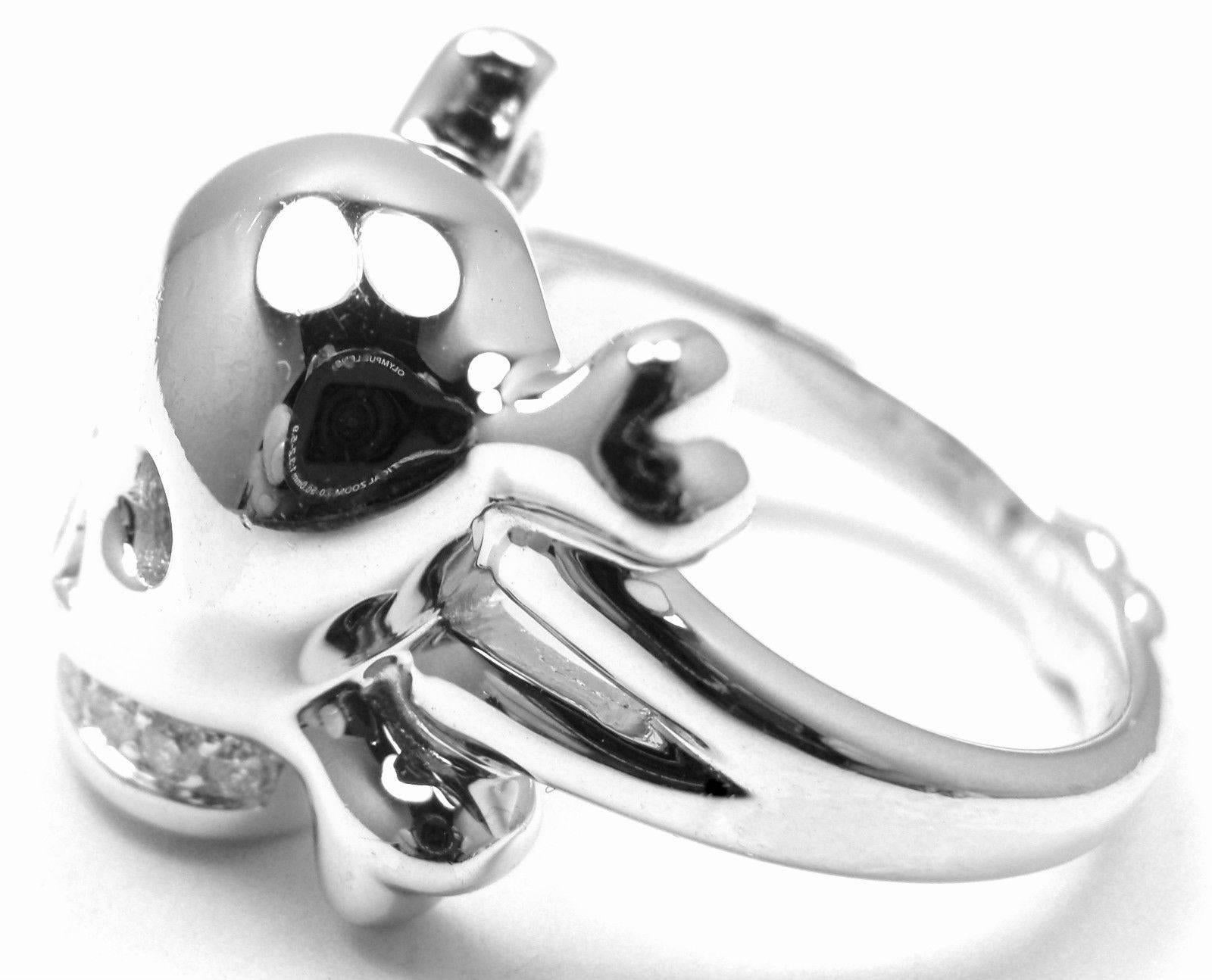 18k White Gold Tete de Mort Diamond Skull Ring by Christian Dior. 
Smooth skull and crossbones with diamond encrusted teeth, representing eternal love. 
Very rare, sold out piece by Christian Dior. 
With 8 diamonds, VVS1 clarity, E color. Total