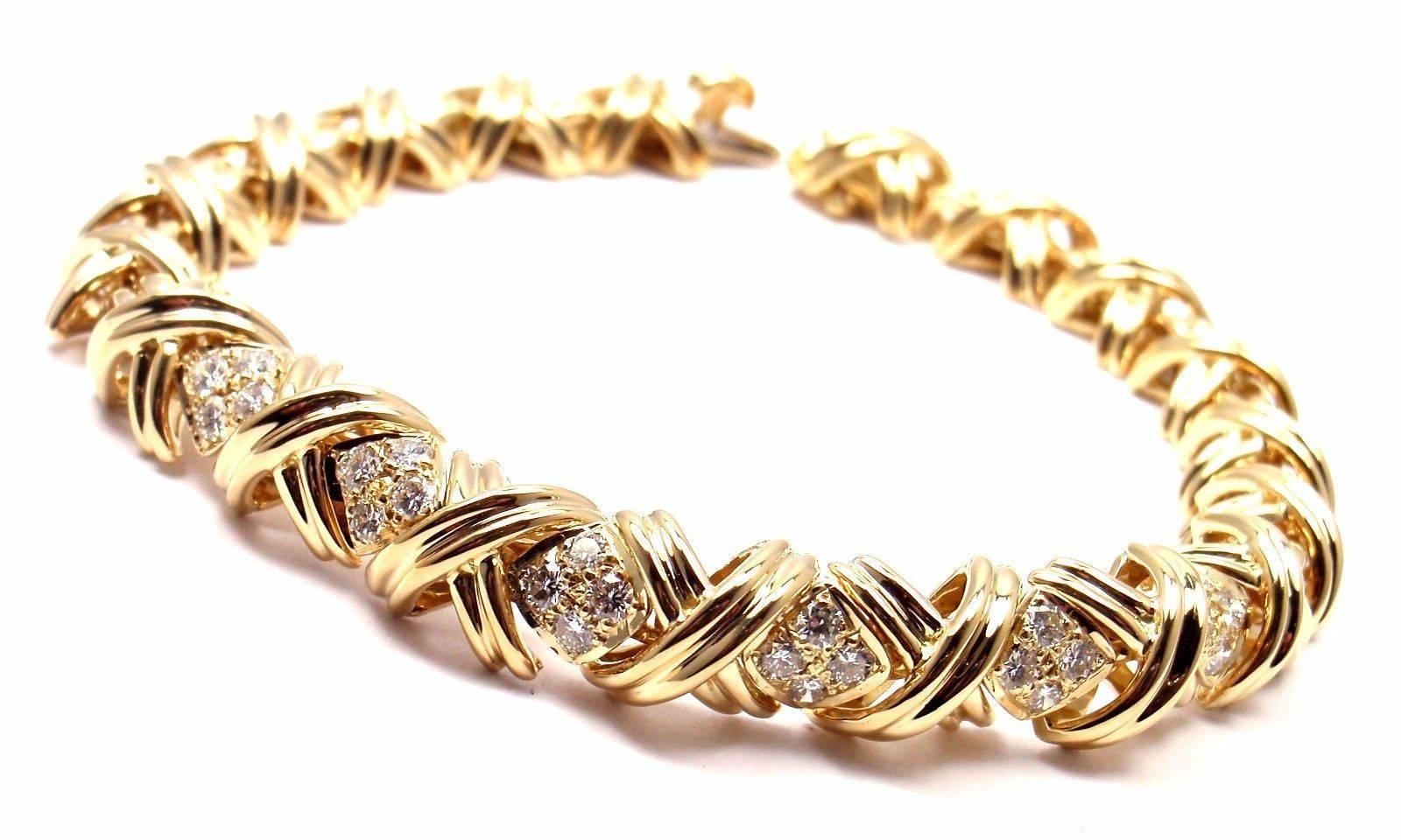 18k Yellow Gold Signature X Diamond Bracelet by Tiffany & Co.
With 24 round brilliant cut diamonds VS1 clarity, G color total weight approx. .72ct

Details:
Weight: 29.4 grams
Length: 7