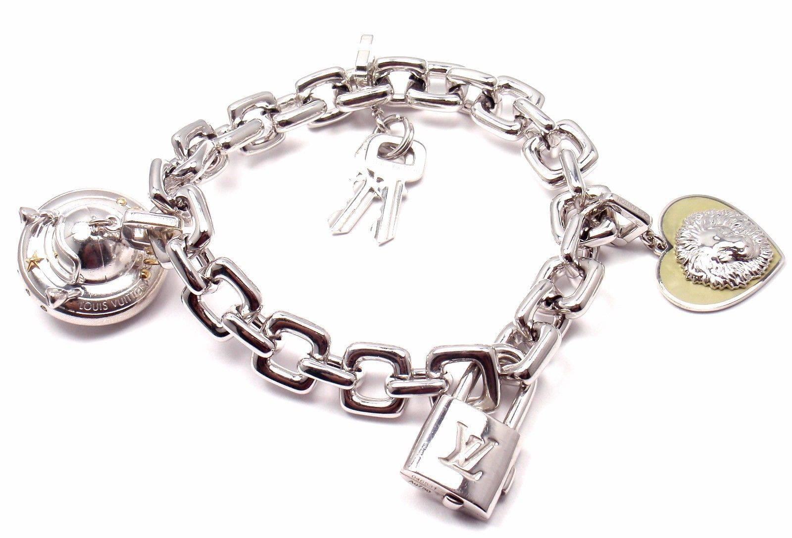 18k White Gold Charm Large Link Bracelet With Charms By Louis Vuitton.
This bracelet comes with three charms: key charm, UFO charm and Be well Lion charm.
With 1 blue sapphire and 2 pink sapphires.

Details:
Length: 8
