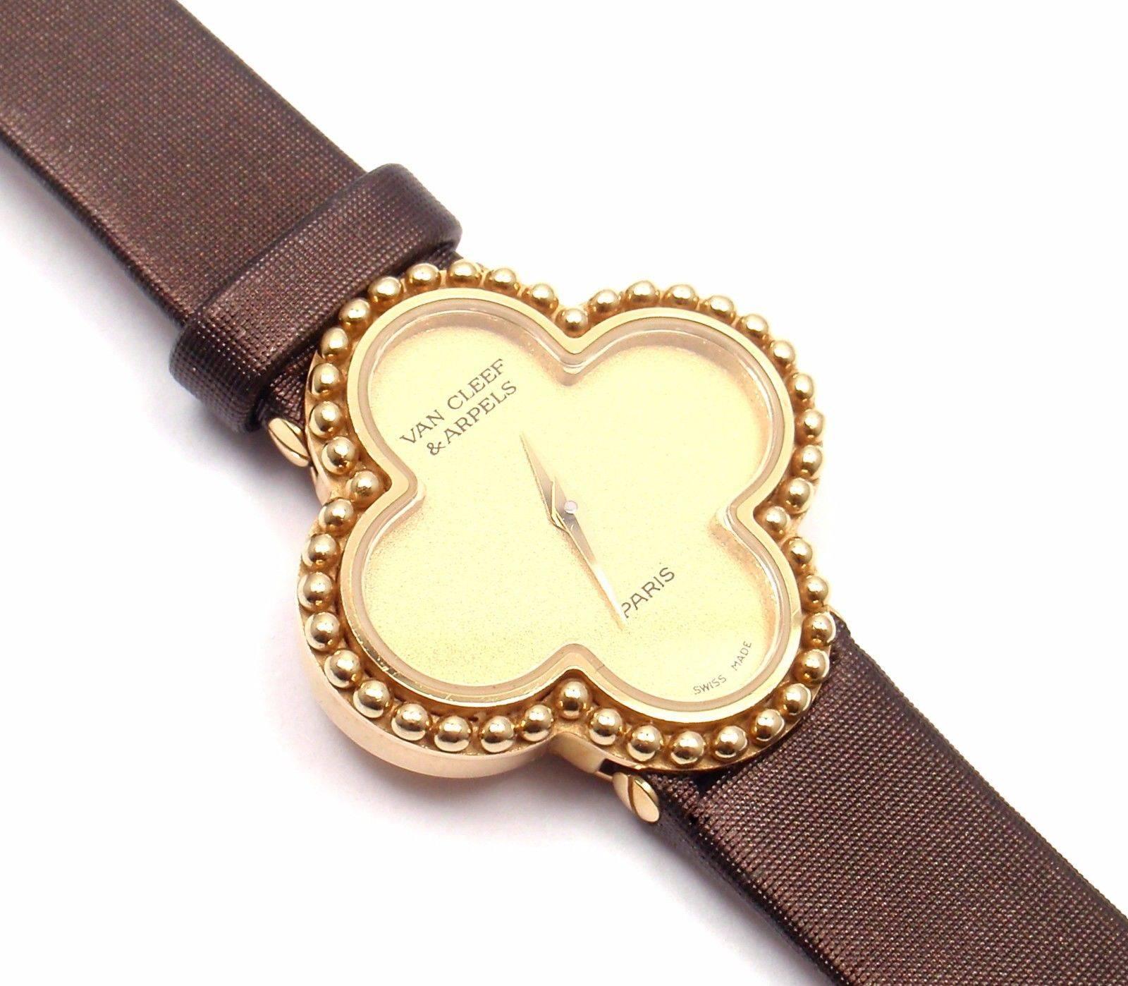 18k yellow gold Vintage Alhambra lady's quartz wristwatch designed by Van Cleef & Arpels. 

Details: 
Case Size: 26mm x 26mm
Band: New! Brown Satin Strap with original VCA 18k Yellow Gold Buckle
Dial: Gold color
Movement: Quartz
Stamped