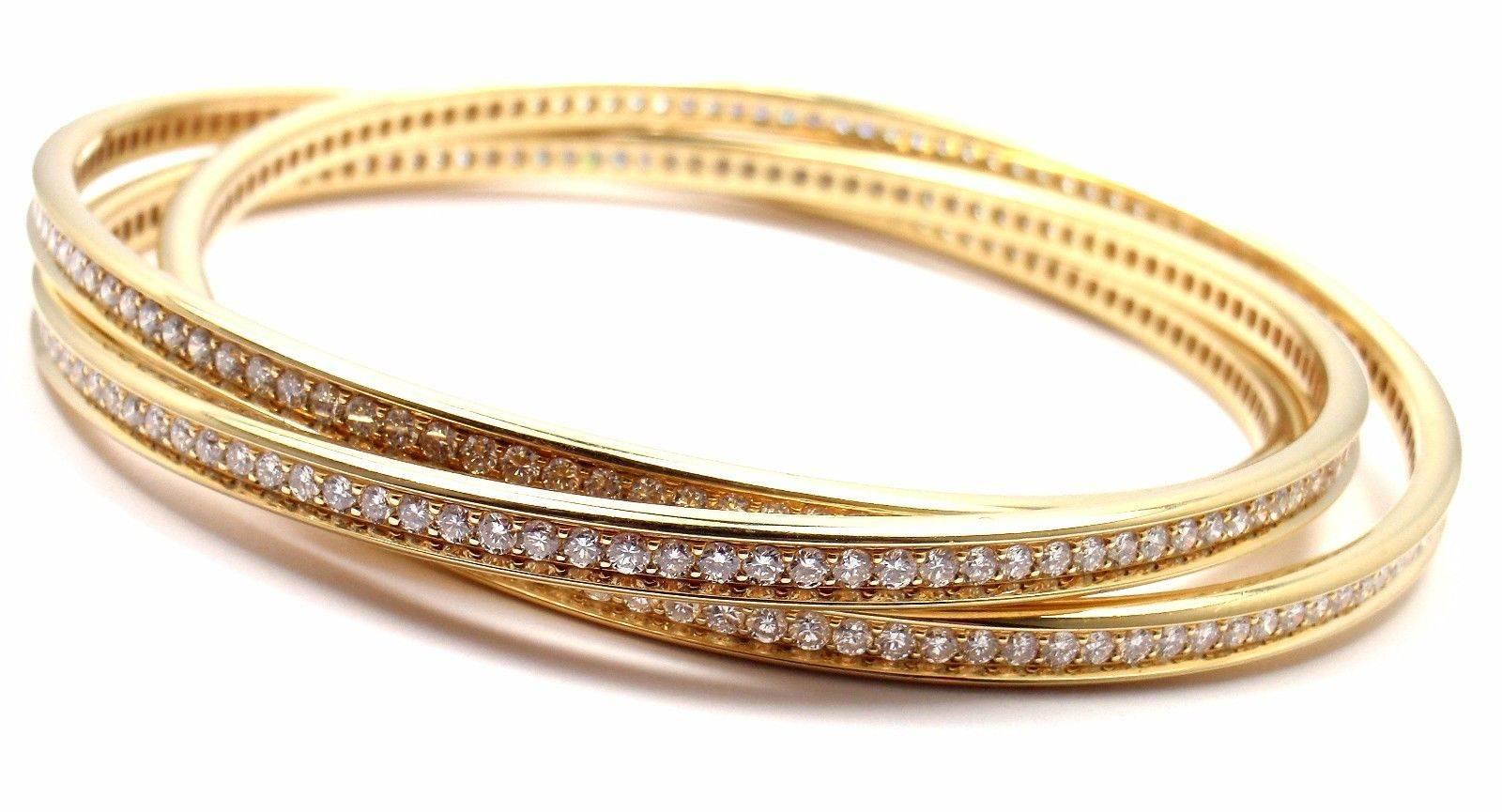 18k Yellow Gold Diamond Trinity Bangle Bracelet by Cartier. 
 With Round brilliant cut diamonds E color, VVS1 clarity 
total weight approx. .7ct
 This bracelet comes with original Cartier box.
 
 Details:
 Length: 7
