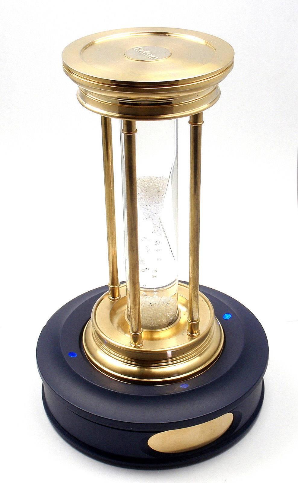 Very Rare! Limited Edition Millennium 2000 Diamond Brass Hourglass Timer by De Beers.
This item comes with lighted pedestal, box and certificate.

This hourglass was just sold on June 3, 2015 at Christies for $41,285.

Containing a cascade of