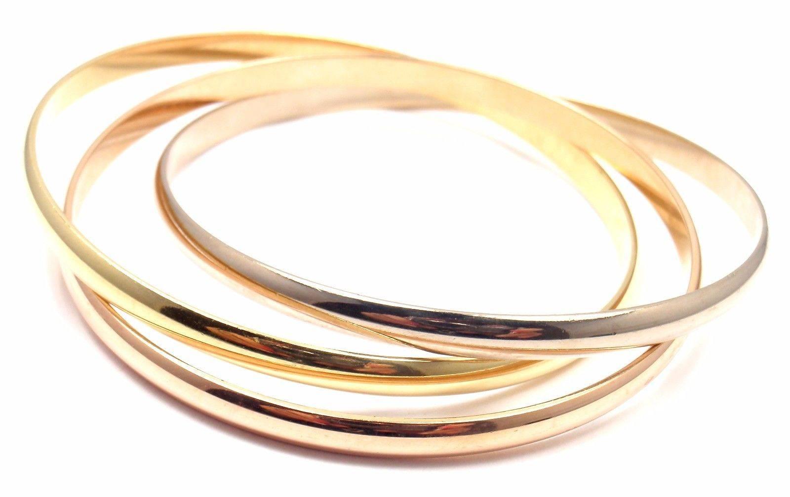 18k Tri-Colored Gold (Yellow, White, Rose) Trinity Rolling Bangle Bracelet by Cartier. 
This is a medium sized bangle. 

Details: 
Length: 7