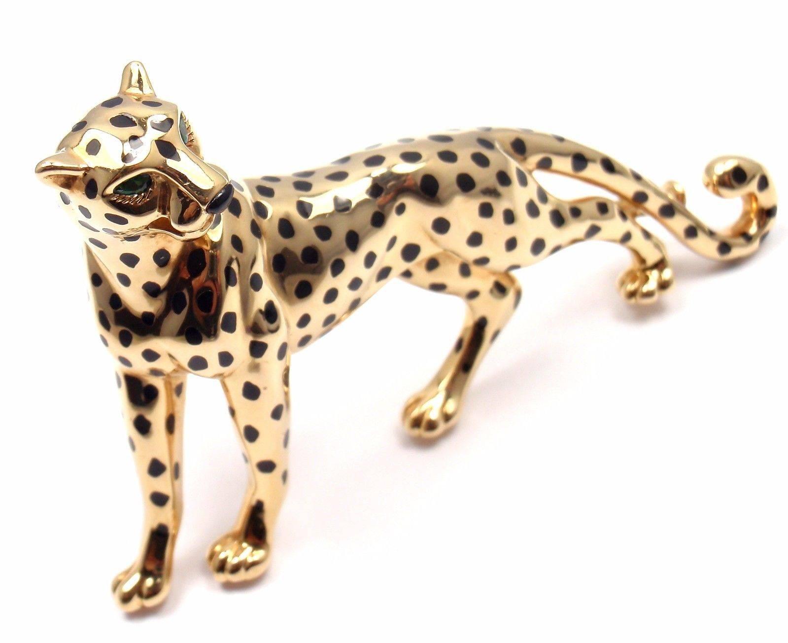 18k Yellow Gold Onyx Emerald Large Panther Pin Brooch by Cartier. 
This brooch comes with an original Cartier box. 
With Black Onyx Spots, Emerald eyes.
 
 Details: 
 Measurements: 2 1/2" x 1 3/4"
 Weight: 32.6 grams
 Stamped Hallmarks: