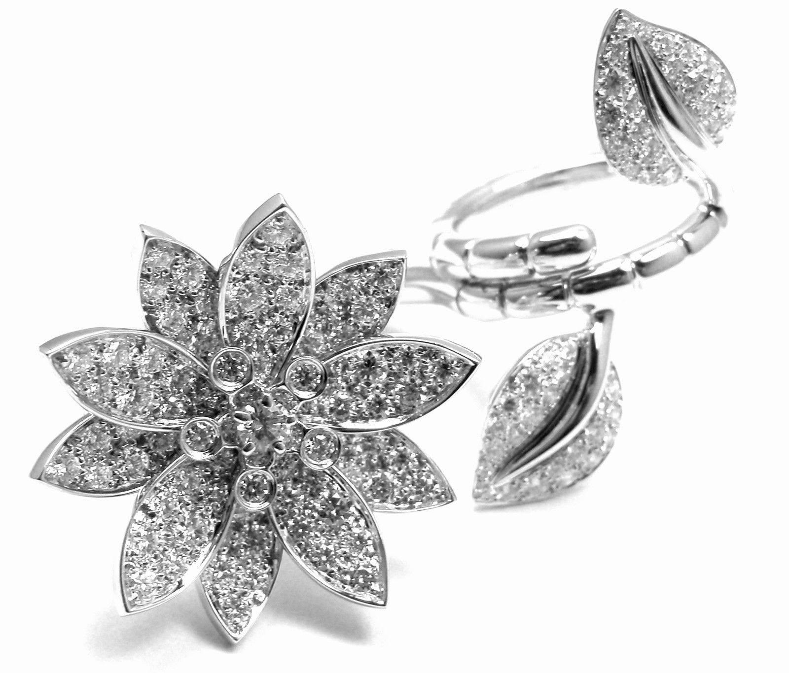 18k White Gold Lotus Flower Diamond Between The Finger Ring by Van Cleef & Arpels.  
With 127 round brilliant cut diamonds VVS1 clarity, E color
total weight approx. 2.26ct 
This ring comes with Van Cleef & Arpels box.  

Details:  
Weight: