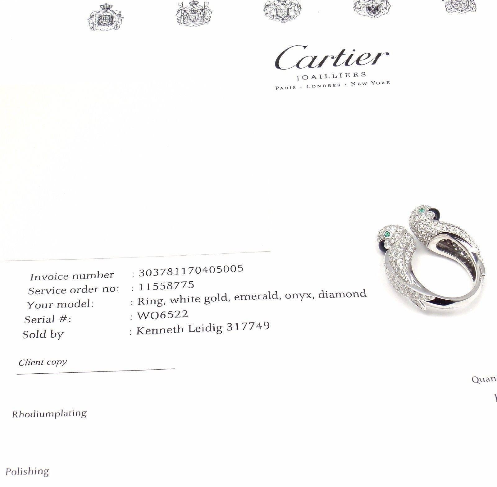18k White Gold Les Oiseaux Libérés Love Birds Diamond, Emerald and Onyx Ring by Cartier. 
With Round brilliant cut diamonds VVS1 clarity, E color
2 round emeralds in the eyes
2 black onyx beaks
This ring comes with Cartier service paper from