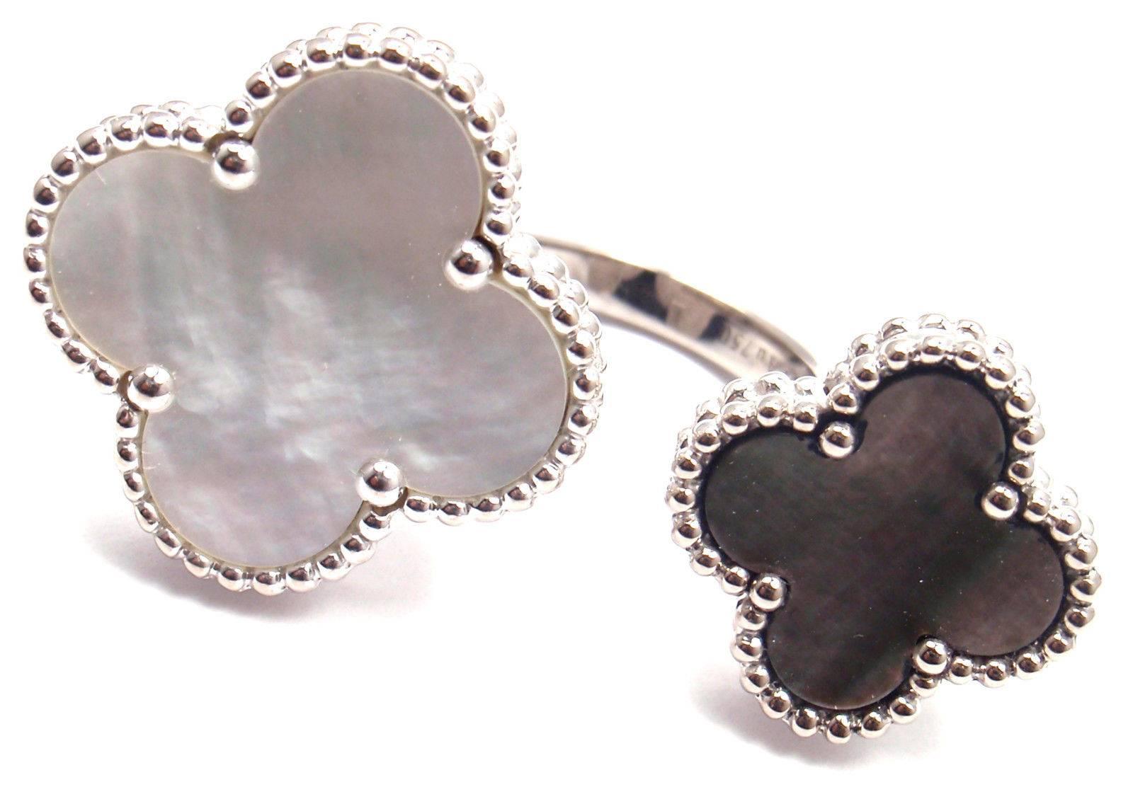 18k White Gold White & Grey Mother Of Pearl Alhambra Between The Finger Ring by Van Cleef & Arpels.
With 2 Alhambra shape mother of pearl stones white & grey.

Details:
Size - 49 - US 4 3/4
Width: Larger 20.5mm Smaller 16mm
Weight: 16 grams
Stamped