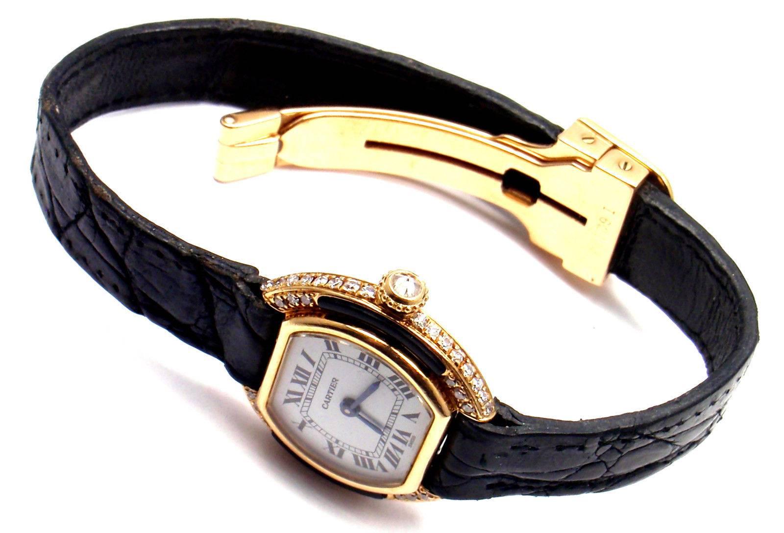 18k Yellow Gold Ellipse Diamond Lady's Wristwatch by Cartier with Original Cartier Manual Wind. 
With Round brilliant cut diamonds VVS1 clarity, E color and Black Onyx and a diamond crown.

Details: 
Case Dimension: 26mm x 23mm
Band: Original