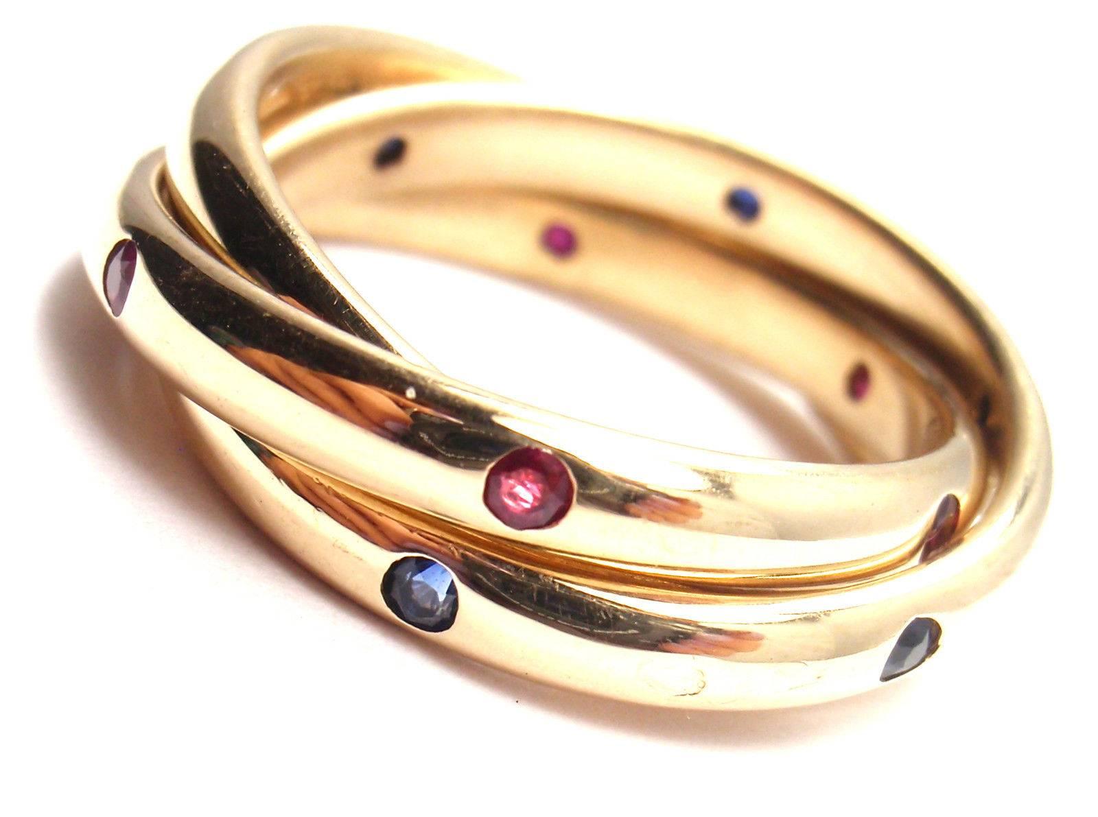 18k Yellow Gold Diamond Ruby Sapphire Trinity Band Ring by Cartier. 
With 6 round brilliant cut diamonds VS1 clarity, G color total weight approx. .18ct 6 rubies & 6 sapphires

Details: 
Size: European 53 US 6 1/4
Weight: 10.6 grams
Width: 7mm