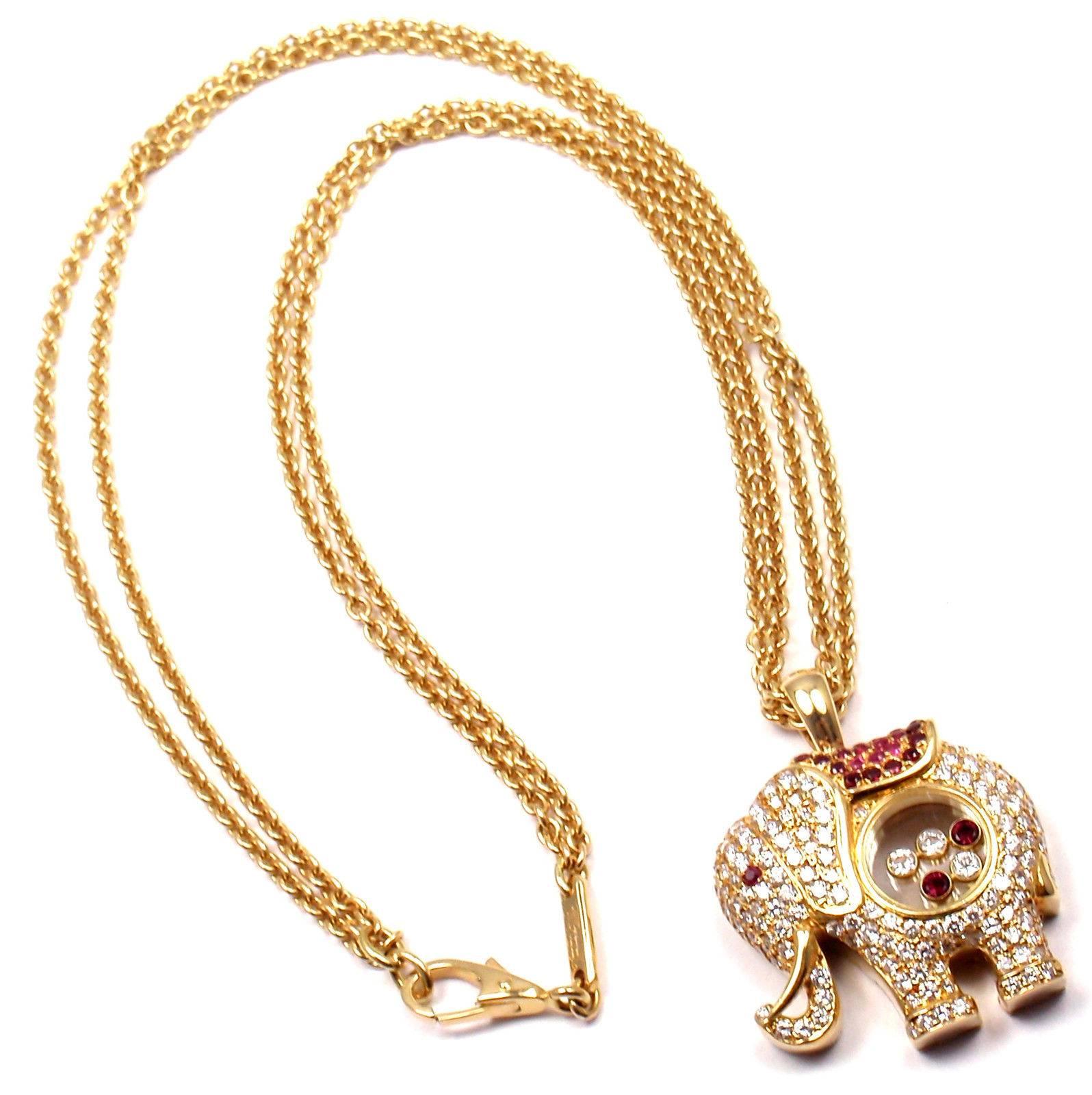 18k Yellow Gold Happy Elephant Diamond And Rubies Large Pendant Necklace by Chopard.  
With 22 round floating diamonds VS1 clarity, E color total weight approx. .22ct
3 round brilliant cut floating diamonds VS1 clarity, E color total weight .15ct
1