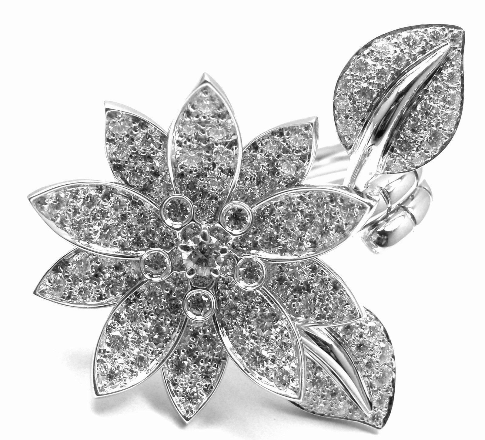 18k White Gold Lotus Flower Diamond Between The Finger Ring by Van Cleef & Arpels.  
With 127 round brilliant cut diamonds VVS1 clarity, E color
total weight approx. 2.13ct 
This ring comes with Van Cleef & Arpels box.  

Details:  
Weight: 20.3