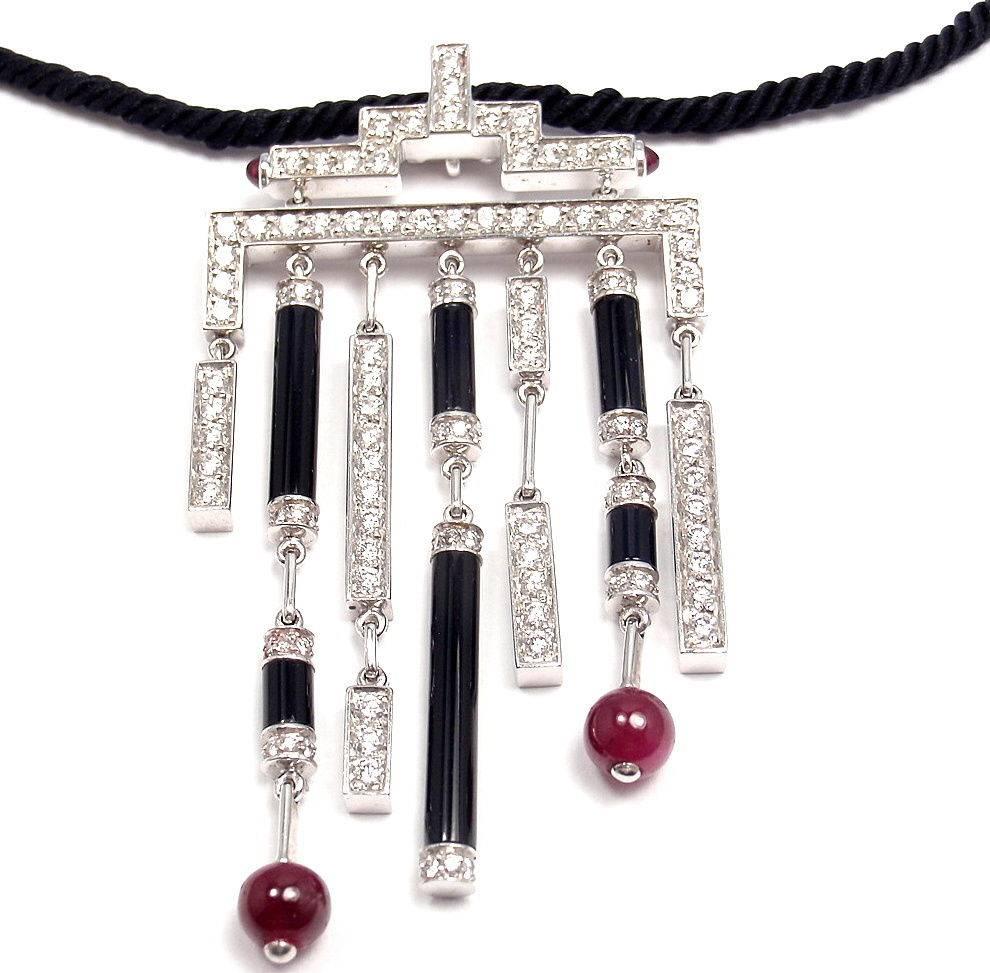 18k White Gold Diamond, Ruby, Onyx Necklace by Cartier. Part of the Cartier Le Baiser Du Dragon Collection. 
With 100 round brilliant diamonds, E color, VVS1 clarity. Also with 6 onyx stones, and 2 ruby beads. 
This necklace comes with Cartier