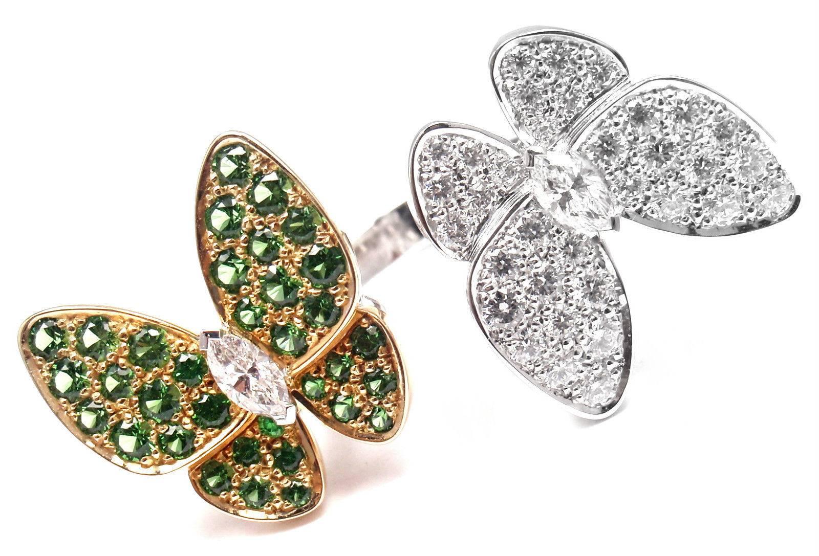 18k White Gold Diamond And Tsavorite Two Butterfly Between the Finger Ring by Van Cleef & Arpels.
With 36 round brilliant cut diamonds VVS1 clarity, E color total weight approx. .99ct
34 round sapphires 1.23ct
This ring comes with Van Cleef & Arpels