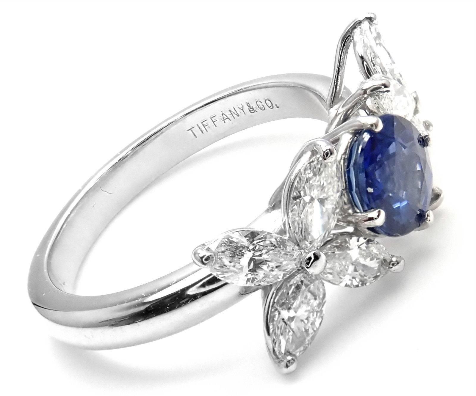 Platinum Diamond Sapphire Victoria Ring by Tiffany & Co. 
With 8 marque shape diamonds VS1 clarity G color
total weight approx. .50ct
1 round sapphire 5mm 
Details: 
Weight: 6.2 grams
Width: 8mm
Ring Size: 5 3/4 (resize available and free of