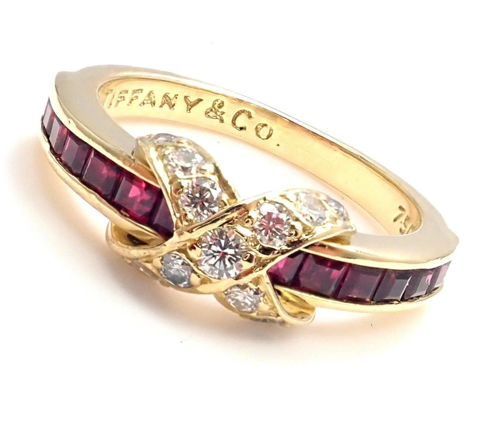 18k Yellow Gold Diamond X Ruby Band Ring by Tiffany & Co.
With 14 round shape diamonds VS1 clarity G color
total weight approx. .28ct and 14 rubies.
Details: 
Ring Size: 6.5 (can be resized)
Weight: 4.2 grams
Width: 6mm
Stamped Hallmarks: Tiffany &