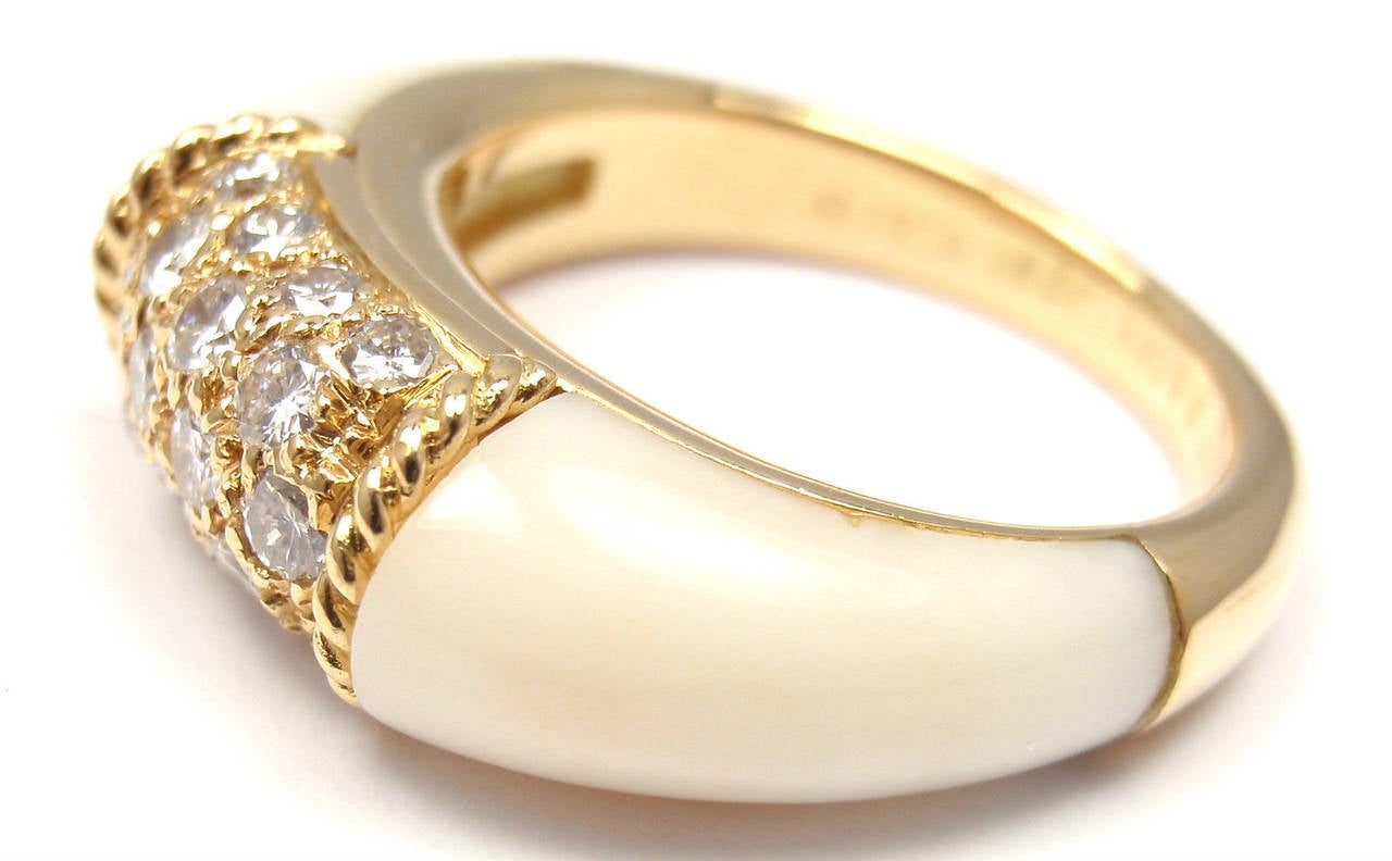18k Yellow Gold Diamond & White Agate Ring by Van Cleef & Arpels.
With 18 round brilliant cut diamond VS1 clarity, G color total weight .51ct
and two White Agate stones

Details:
Size: 5 3/4
Width: 7mm
Weight: 8 grams
Stamped Hallmarks: VCA