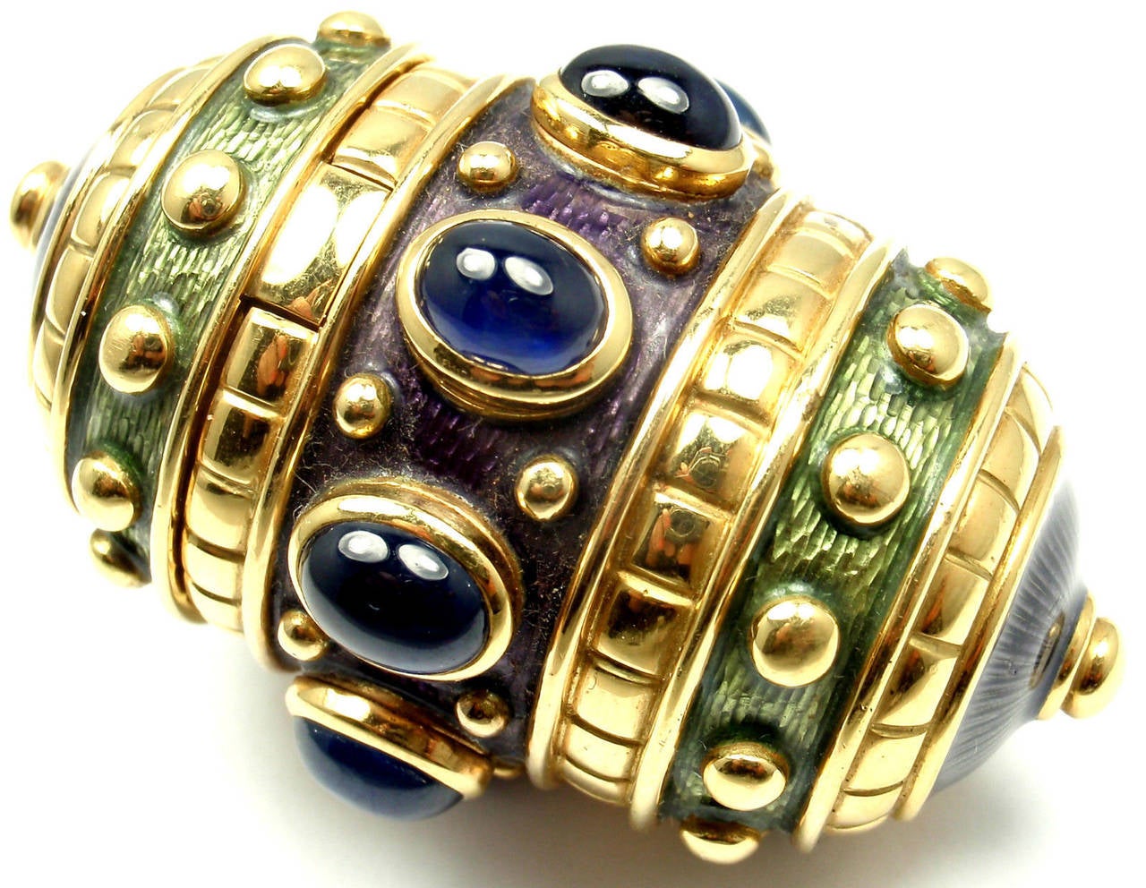18k Yellow Gold Sapphire And Enamel Large Pill Box by AMR Shaker Geneve. With 8 oval cabochon sapphires 9mm x 7mm each

Details:
Measurements: 2 1/4