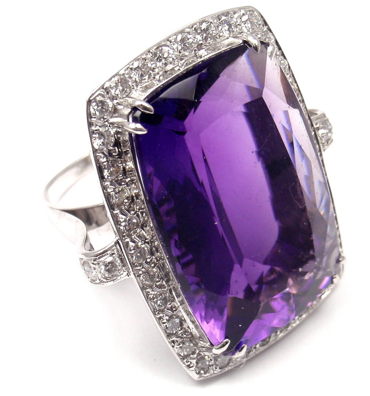 Estate 18k White Gold Diamond Large Amethyst Ring.
With 1.50 ctw in diamonds
1 large amethyst, 18 x 27mm in size

Measurements:
Size: 9
Weight: 16.3 g
Width: 2mm band, 32 x 24mm front

Stamped Hallmarks: Not clearly stamped but tested and