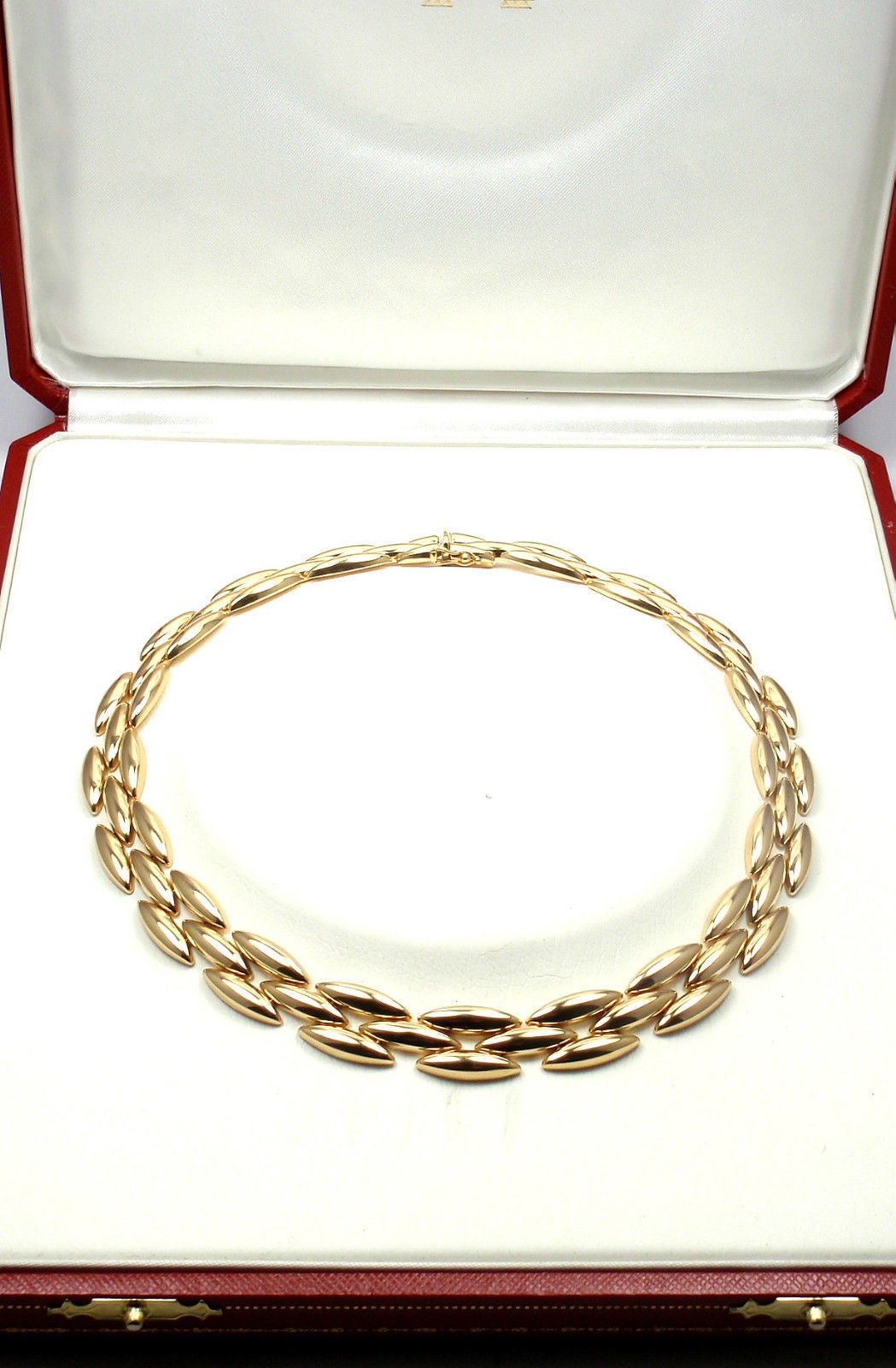 18k Yellow Gold Gentiane 3 Row Rice Link Necklace by Cartier. 
This beautiful necklace comes with an original Cartier box.

Details: 
Length: 15