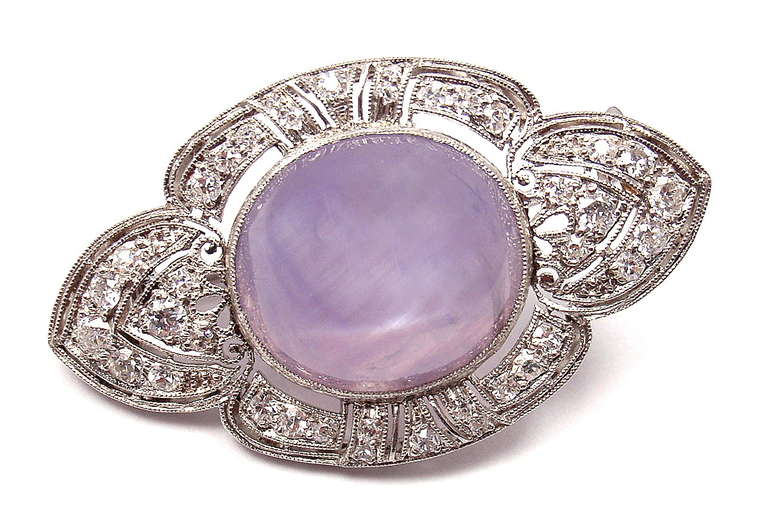Platinum, Diamond and Violet Star Sapphire Brooch Pin by Marcus & Co., 
With 38 round old European cut gem quality diamonds VVS1 clarity E color total weight approx. 1.5ct
1 oval violet start sapphire 15mm x 11mm measurements approx. 14ct