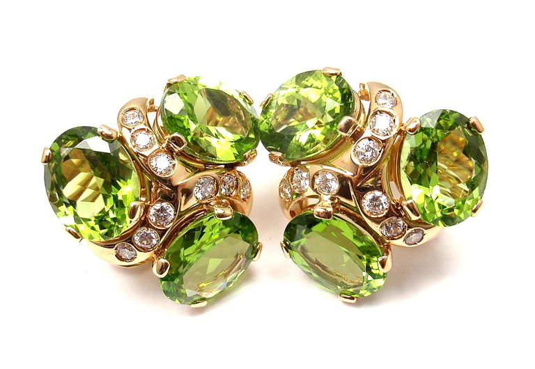 18k Yellow Gold three stone peridot and diamond earrings by Verdura. 
With 18 round brilliant cut diamonds VS1 clarity, G color
6 large oval shape peridots. 
These earrings are for non pierced ears.

Details:
Measurements: 20mm x 22mm
Weight: