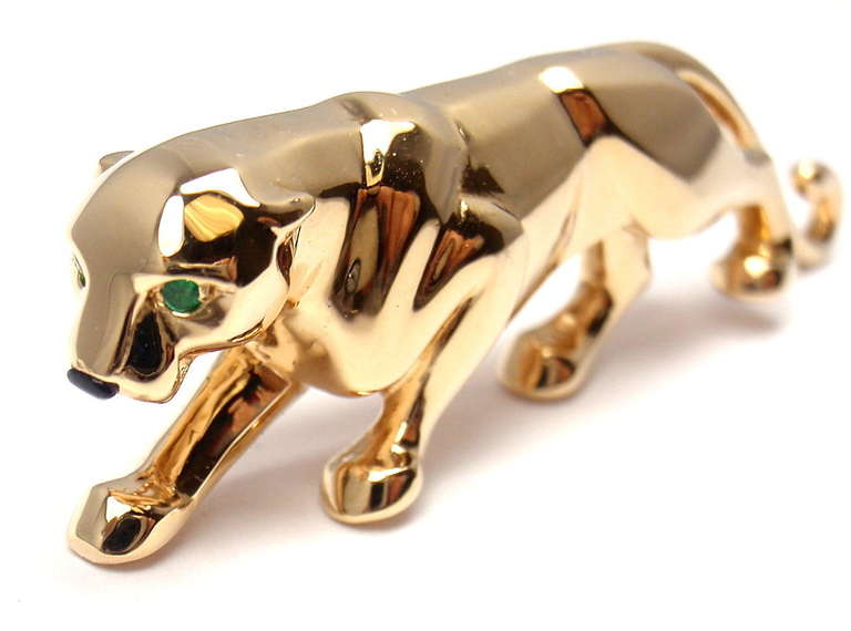 18k Yellow Gold Panther Pin Brooch by Cartier. This brooch comes with an original Cartier box. Panther has 2 emerald eyes and 1 black onyx nose. 

Details: 
Length: 2 1/4