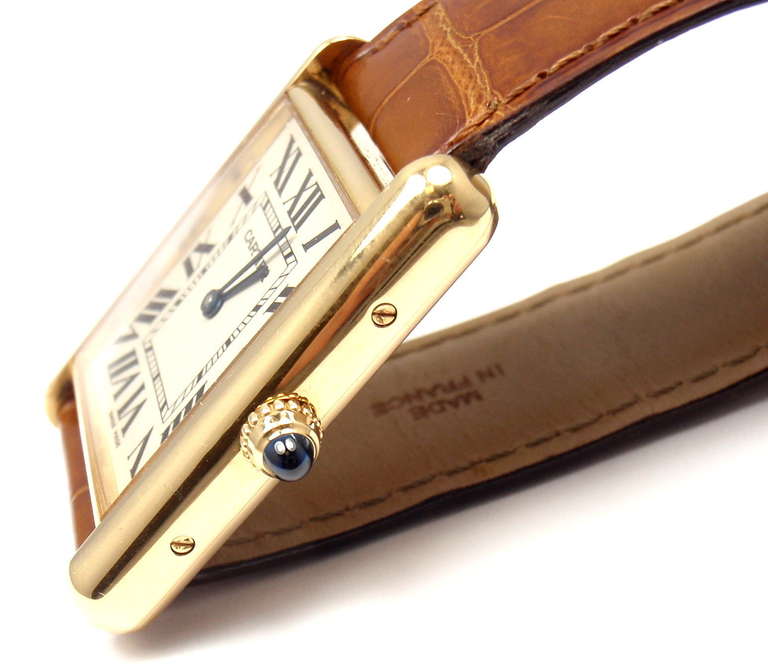 Cartier 18k yellow gold Tank Louis wristwatch with date, comes with a Cartier box.

Details: 
Case Dimensions: 34mm x 26mm
Band: Cartier Brown Leather Band 
Buckle: Cartier 18k Yellow Gold Buckle
Movement: Cartier Quartz
Stamped: Cartier