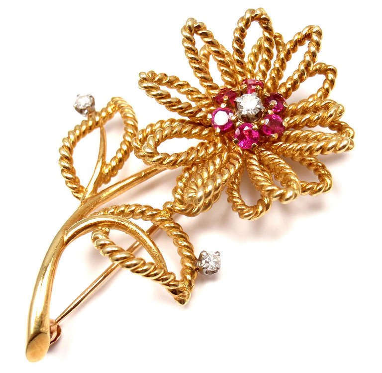 14k Yellow Gold Diamond Ruby Flower Brooch by Tiffany & Co. 
With 3 round brilliant cut diamonds VS1 clarity, G color, total weight 
approximately .20ct
6 round rubies

Details: 
Measurements: 2