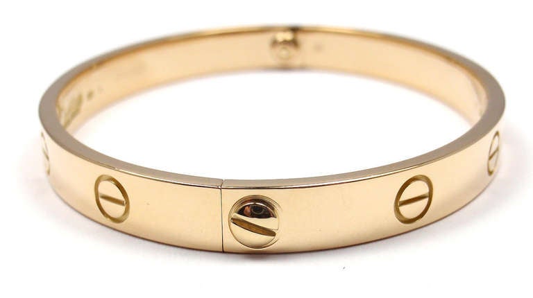 18k Yellow Gold LOVE Bangle Bracelet by Cartier. Size 17. 

This beautiful Cartier Love Bangle comes with an original Cartier box, Cartier certificate and a Screwdriver.

Details:
Weight: 31.1 grams 
Width: 6.5mm
Stamped Hallmarks:  Cartier