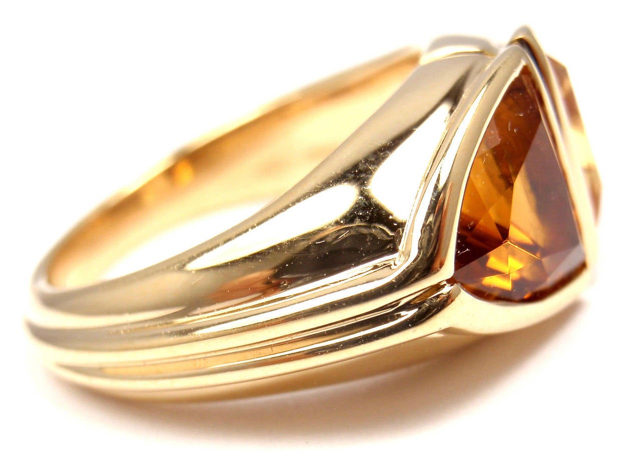 18k Yellow Gold Citrine And Golden Topaz Ring By Bulgari. 
With 1 Citrine 9mm x 9mm
1 Golden Topaz 9mm x 9mm

Details:
Ring Size: 6 1/4 (resize available)
Width: 10mm
Weight: 11.8 grams
Stamped Hallmarks: Bvlgari 750
*Free Shipping within
