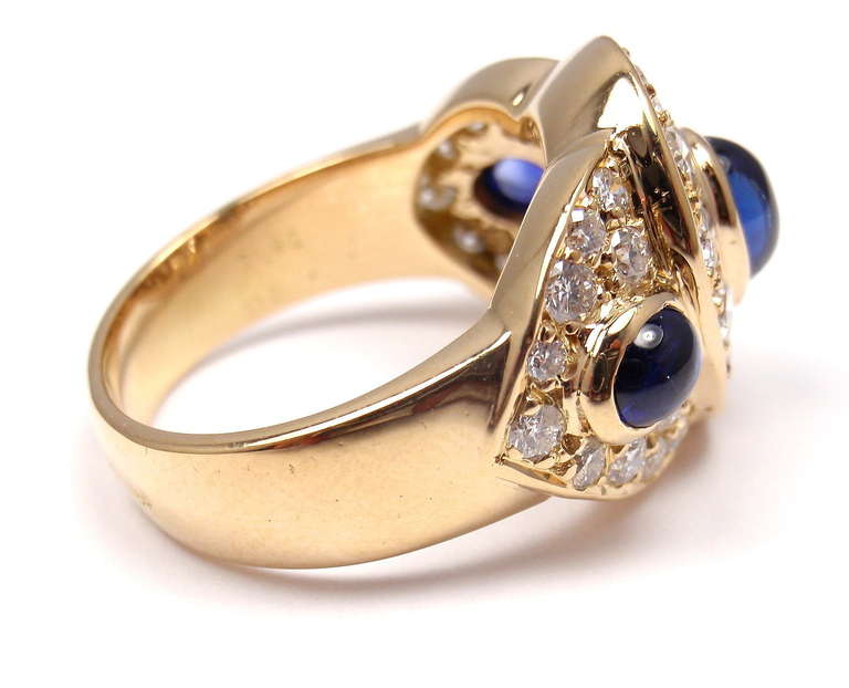 18k Yellow Gold Diamond & Sapphire Ring by Van Cleef & Arpels.
With 30 brilliant round cut diamonds VVS1 clarity, F color
Total weight approx. 1.10ct
3 cabochon sapphire 1.90ct

Details:
Ring Size: 6
Width: 15mm
Weight: 7.9 grams
Stamped